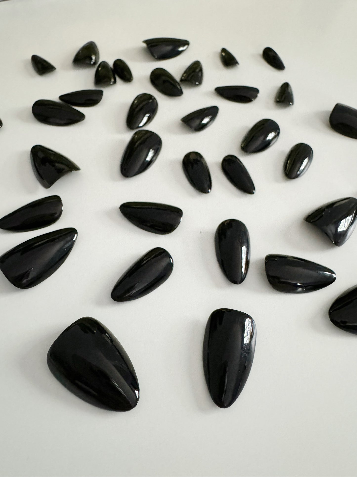 Classic black, short to medium length, almond shaped press on nails.