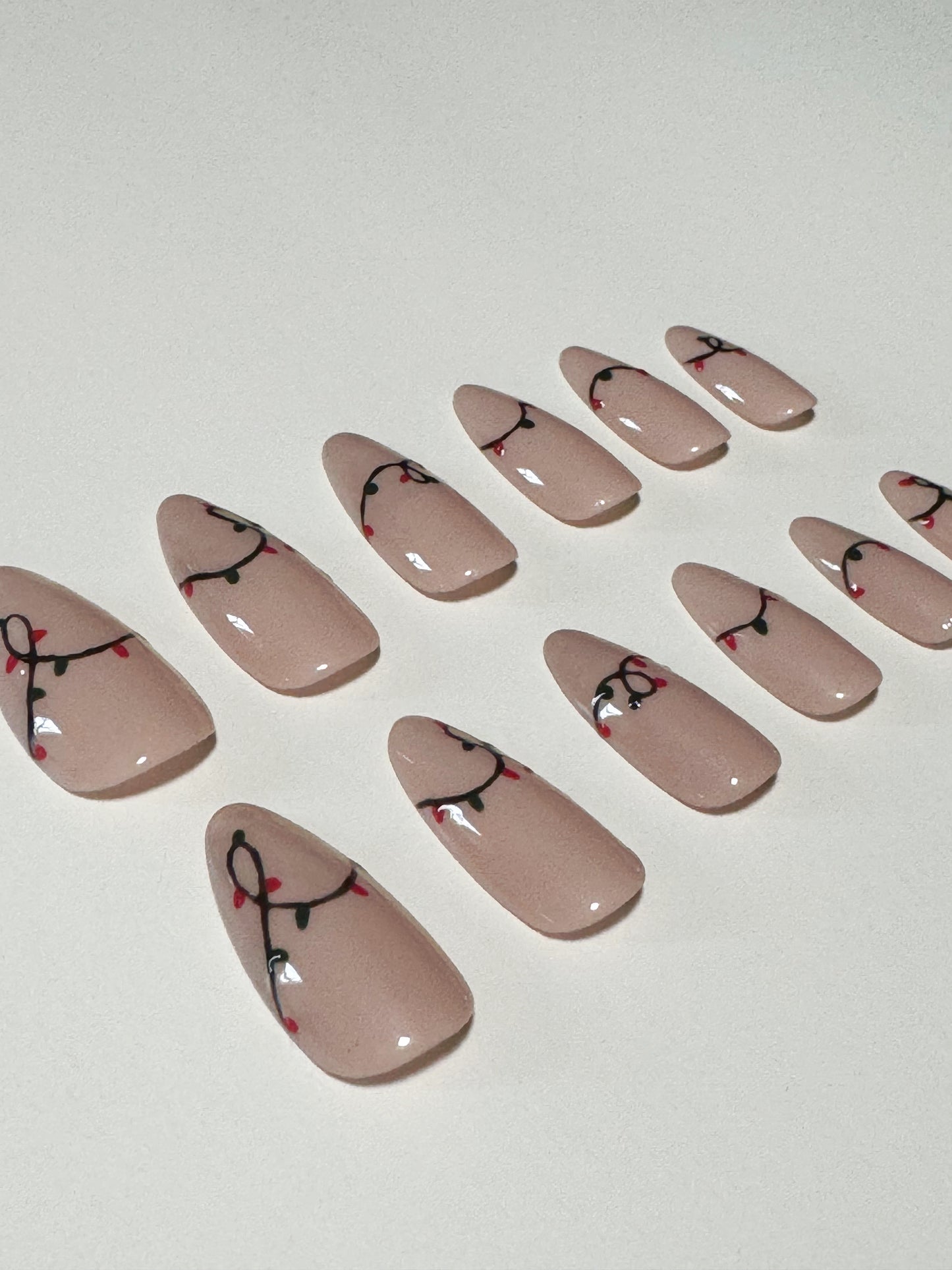 Christmas themed string light design, medium to long length, almond shaped press on nails.