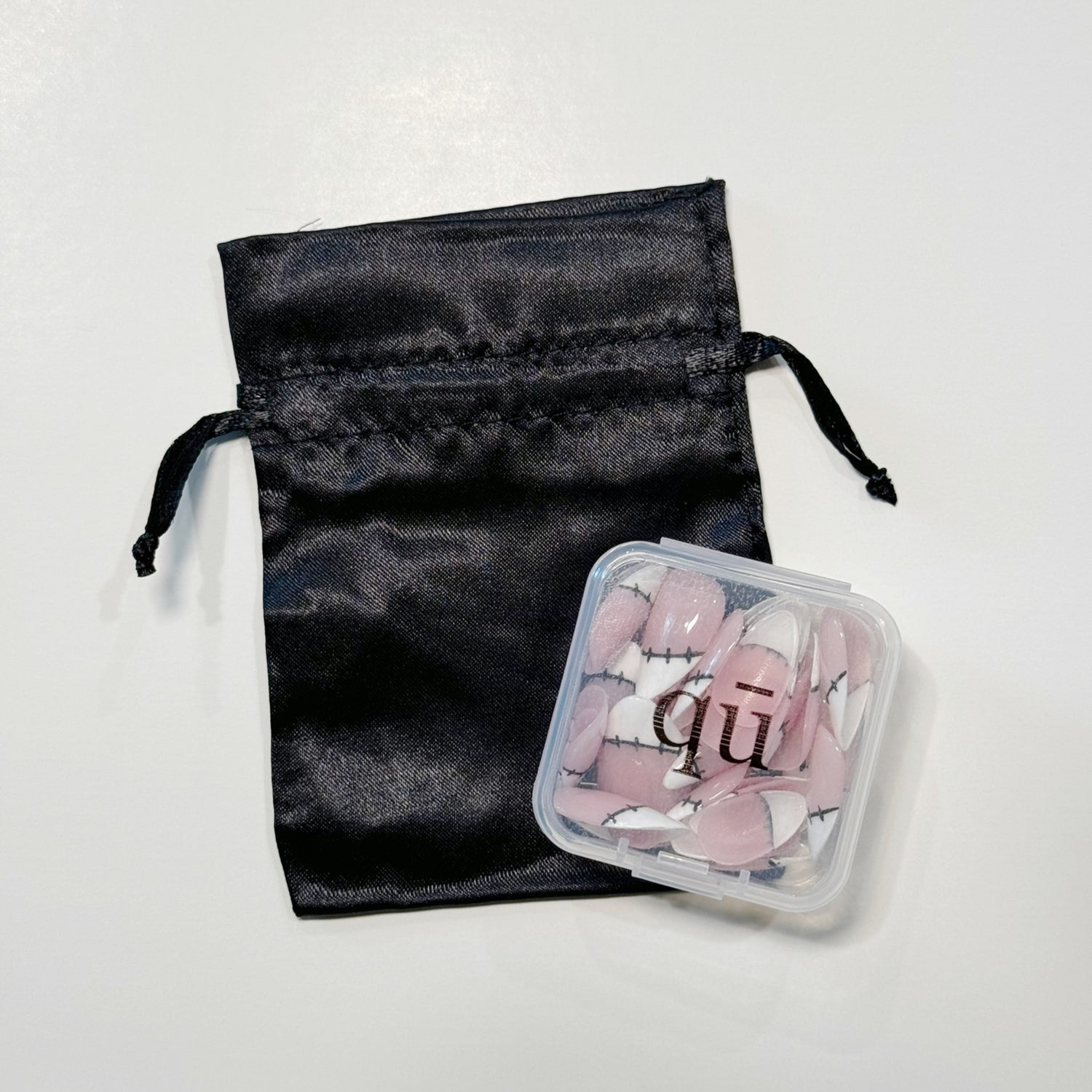 Reusable press on nails with reusable satin bag and carrying case/container.