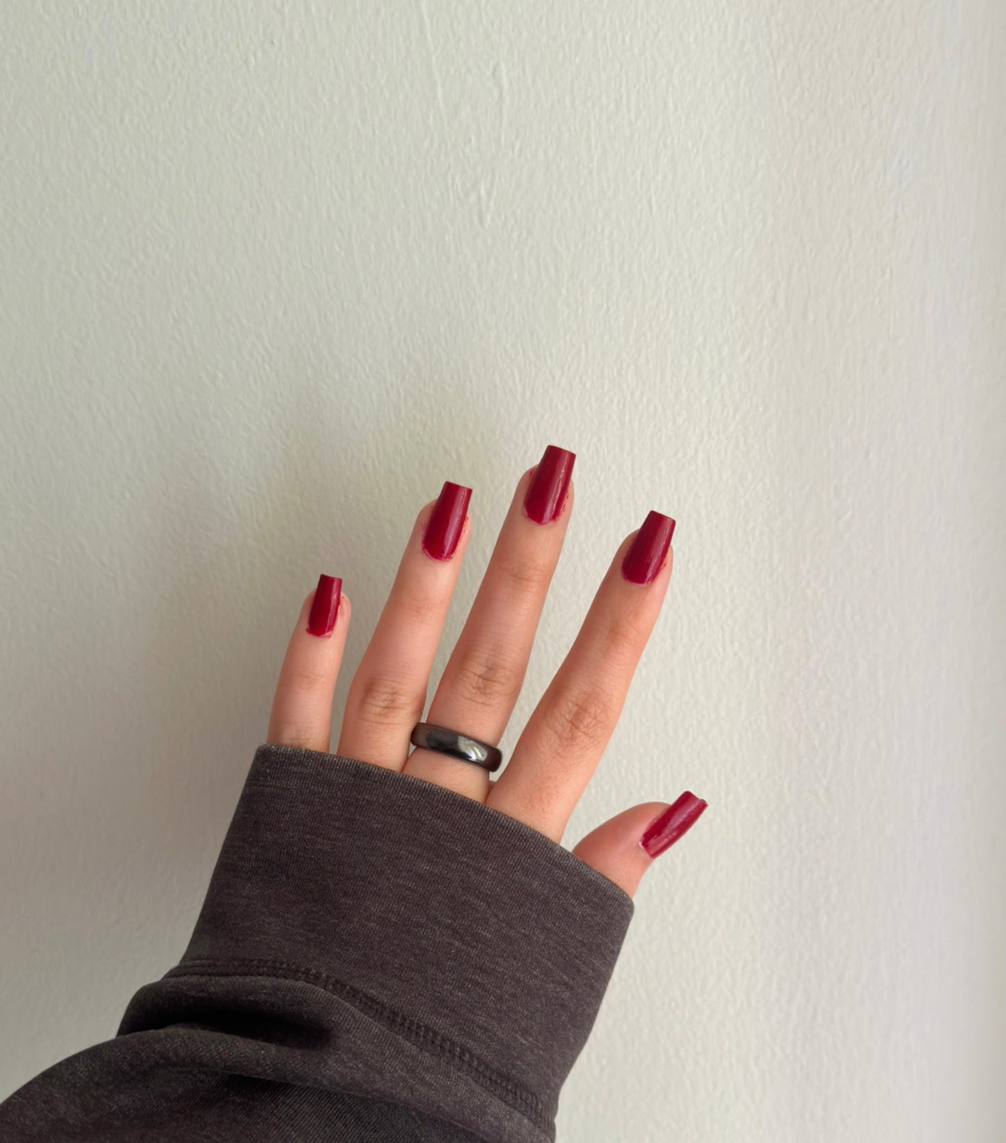 Classic crimson red nail polish.