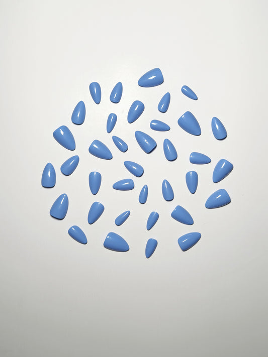 Light blue, short to medium length, almond shaped press on nails.