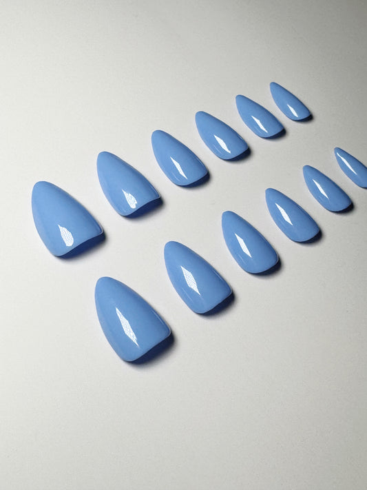 Light blue, short to medium length, almond shaped press on nails.