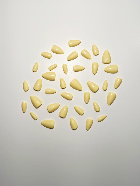 Light yellow, short to medium length, almond shaped press on nails.